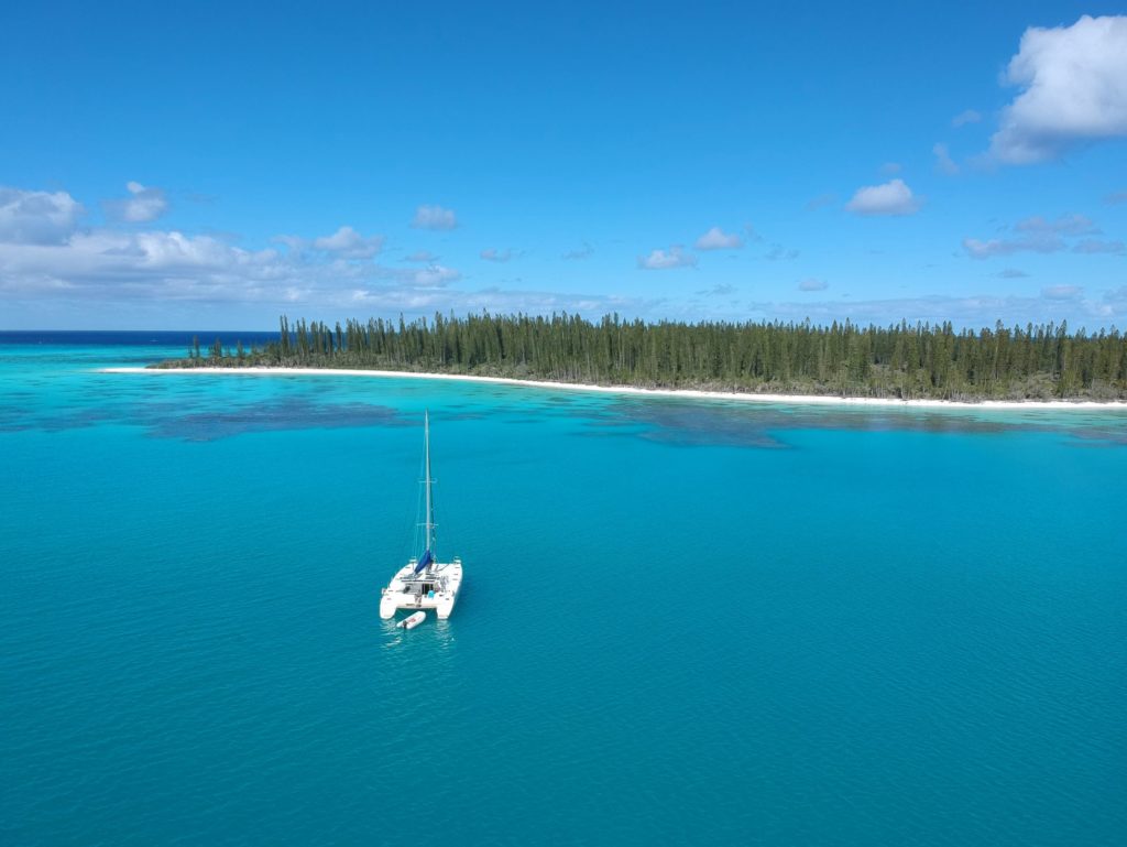 A drone shot of Zoom, a 2009 St Francis 50 bluewater catamaran for sale by owner, anchored off the island of New Caledonia