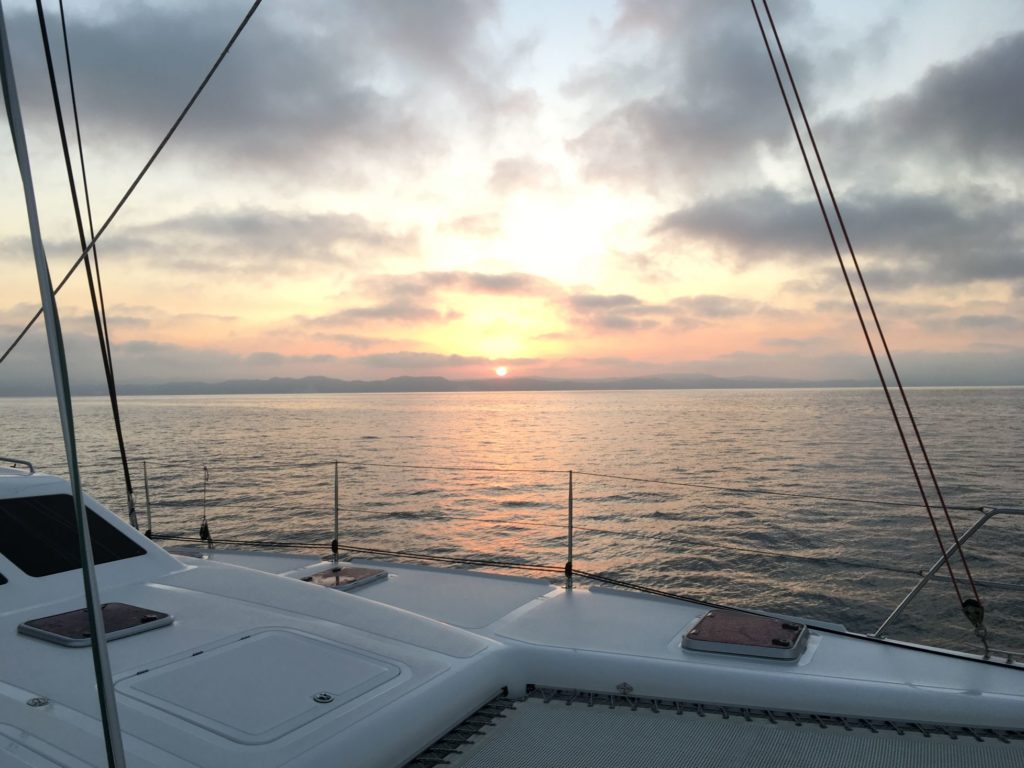 View of the sunset at sea from the decks of the 50-foot bluewater catamaran for sale by owner
