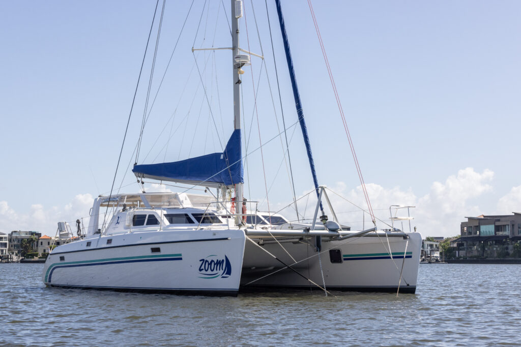 St Francis 50 bluewater catamaran named Zoom shown at anchor near a port